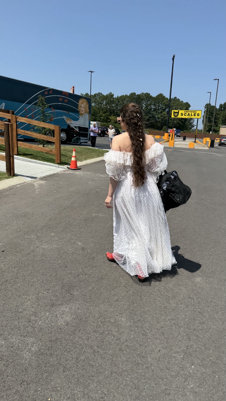 Nettie walking toward Dolly's with gear