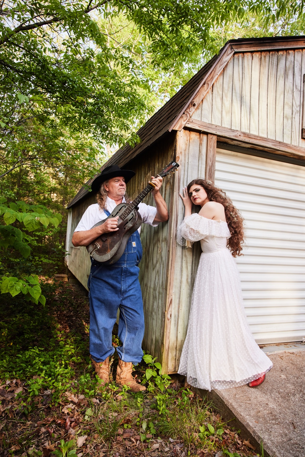 Nettie and the Delta Boy beside a weathered shed